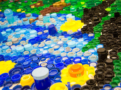 Plastic bottle caps get turned into artwork.
