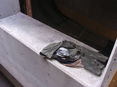 Someone`s sleeping quarters inside a parking garage.