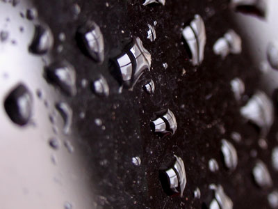 The parking garage window, refracted in little droplets.
