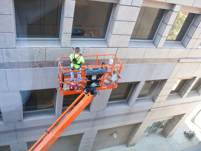 Two people are in this shot, and the reflection of a third.