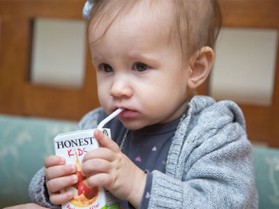 Her first kid`s meal, and moments away from a juice box mishap.