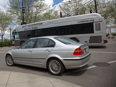 A bus AND a car running a red light in unison.
