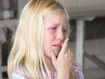 Kids watch as the animals they raised are auctioned off.