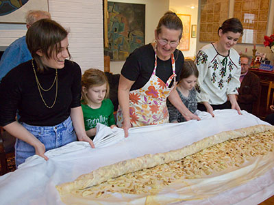 After being filled with apples, it`s rolled into a cylinder.