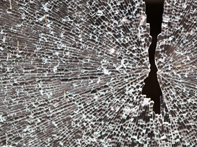 Someone tried to break into this door, but the glass stopped them.  So they just broke through a window.