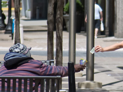 While I worked inside the building all day, this panhandler worked outside.