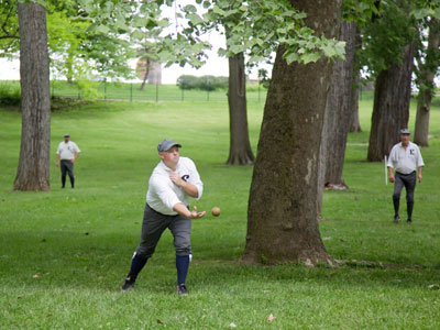 Old-fashioned base ball among the trees.