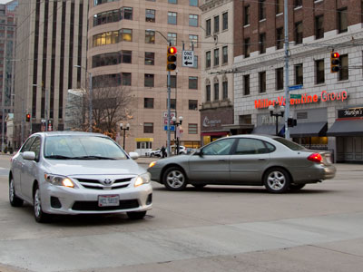 Red lights and crosswalks mean nothing at this intersection, which makes it so dangerous to cross.