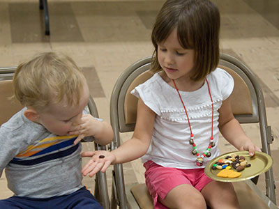 She`s happy to share raisins with her little brother . . . 