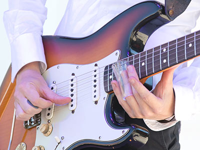 A long time ago, some blues guitarist got the idea to put a broken bottleneck on his finger while he played.