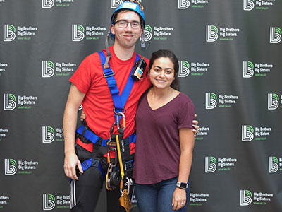 My fearless nephew (with his lovely bride) before he climbed down a 27-story building for a good cause.