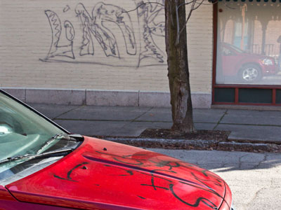 Brilliant.  Graffiti on the wall and car.