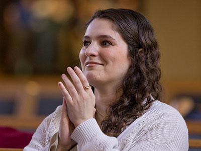 Composer Morgan Moss reacts as her new choral work is sung for the first time.