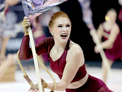 Please note she`s spinning a flag while her arms are constrained by a rope.  Try it sometime.