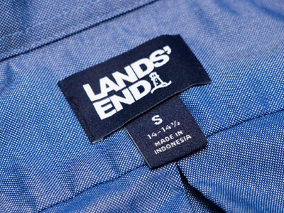 I now wear a small, apparently, due to vanity sizing.