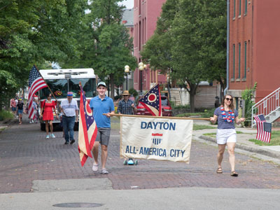 Patriotic people participate in a pleasant parade.