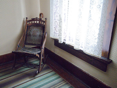 Mother Dunbar`s chair is next to an upstairs window.