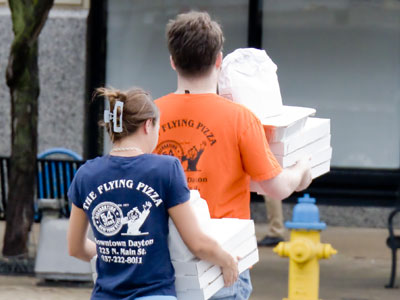 I don`t know where they`re going with armloads of pizza, but I want to be there.