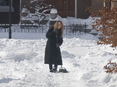 No City of Dayton snowplows have come by yet, but we do have this lady with a broom doing her civic duty.