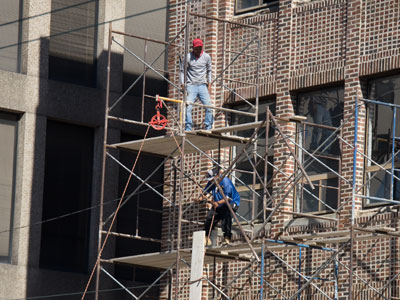 A crew with no hardhats or harnesses works to make Rabbit Hole Books a safer place (see April 28, 2026).